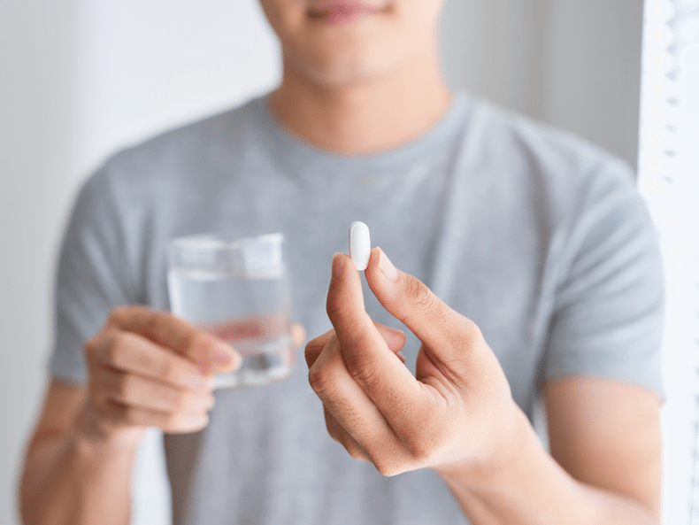 a man holds a Weiprost capsule for prostatitis